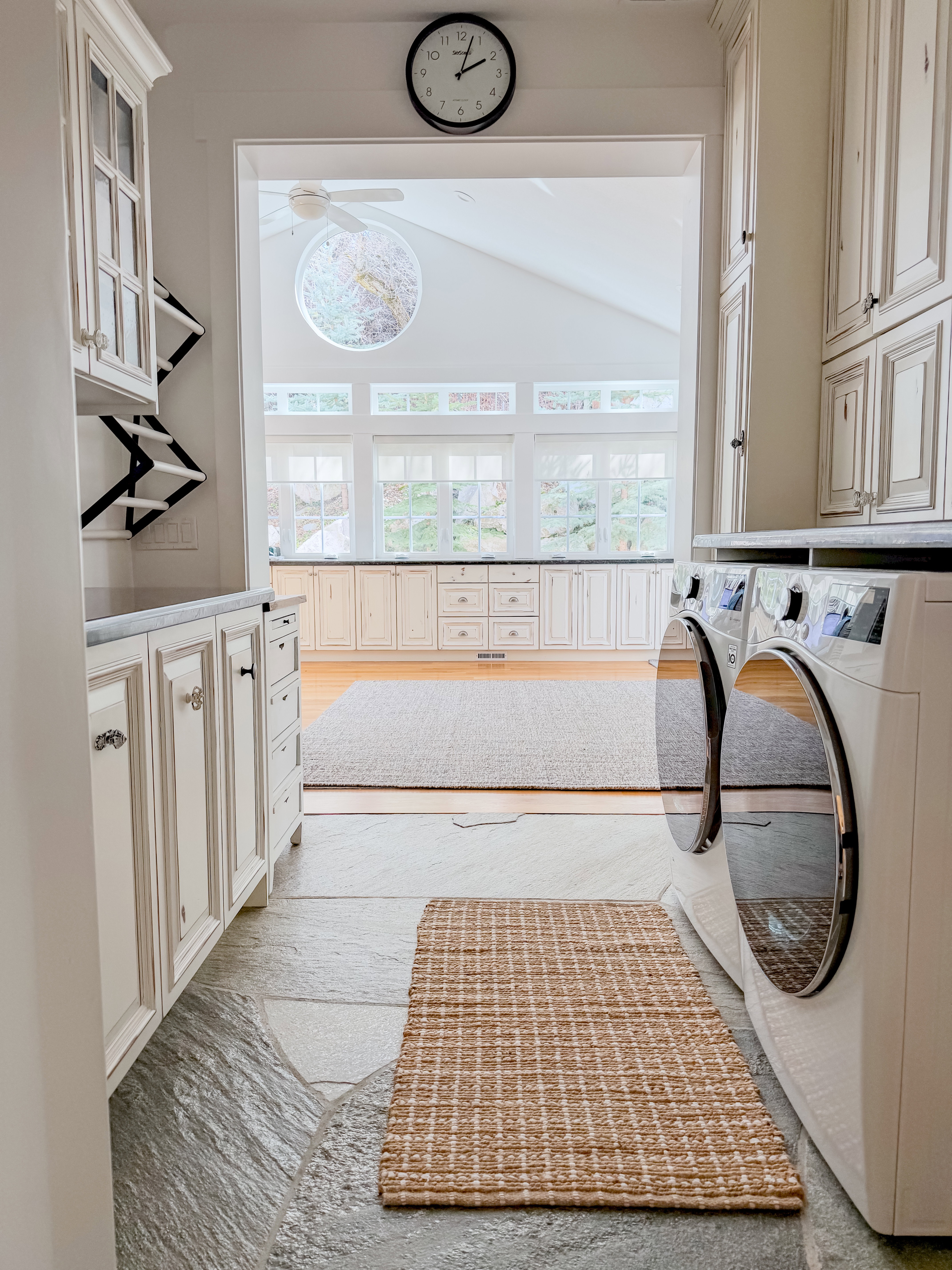 Laundry room with cabinet space, washing machine and dryer, lofted ceiling, and light wood-style flooring