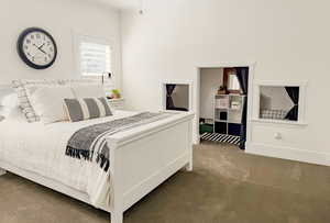 Carpeted bedroom with ornamental molding and baseboards