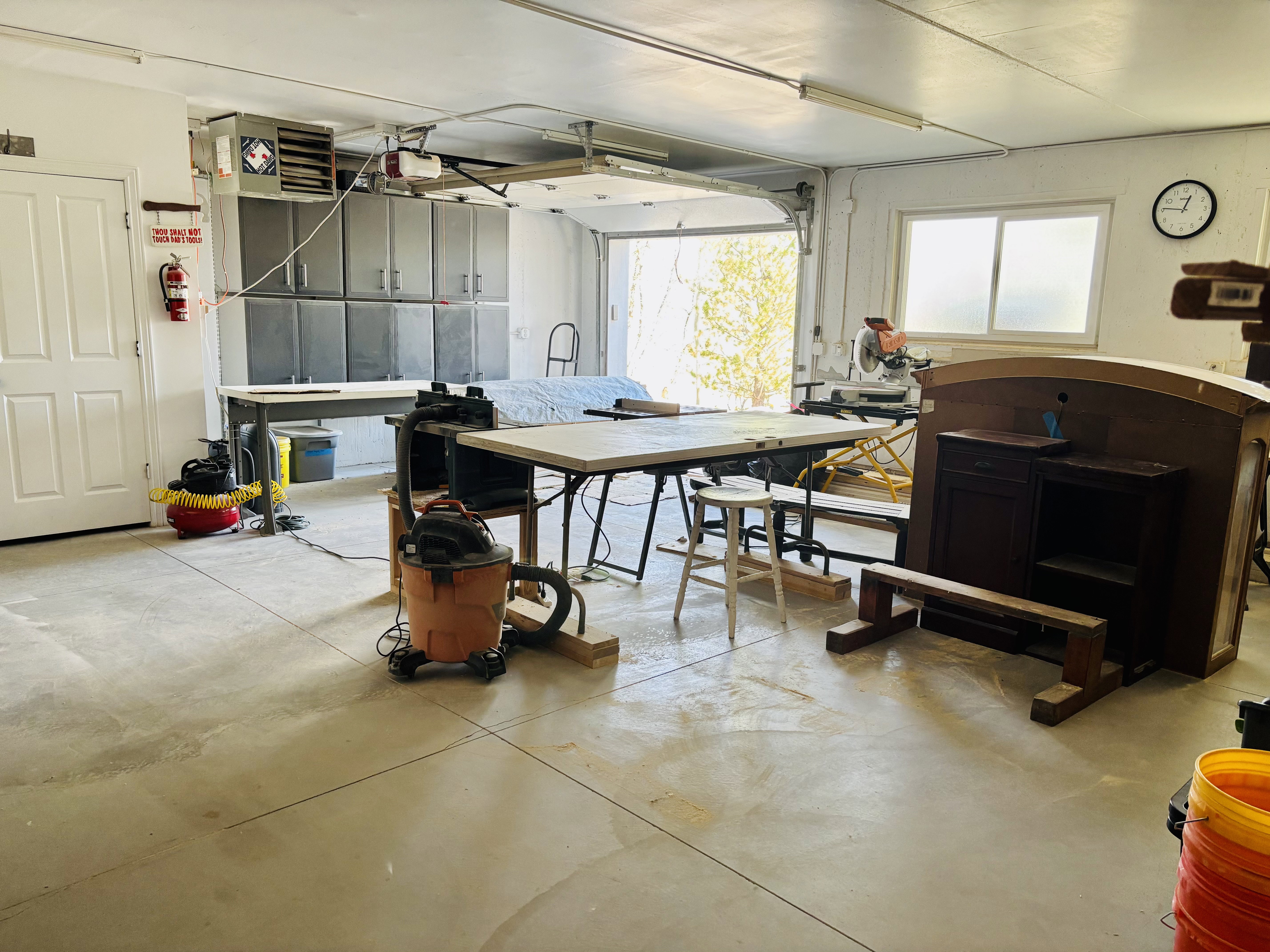 Garage with a heating unit and a workshop area