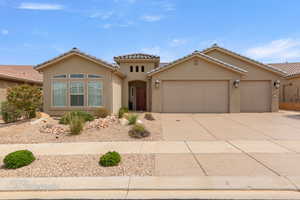 Mediterranean / spanish home featuring an attached garage, stucco siding, concrete driveway, and a tile roof