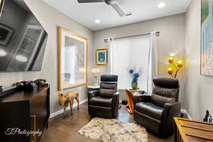 Sitting room featuring dark wood-style flooring, ceiling fan, and recessed lighting