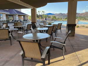 View of patio with a mountain view and a community pool