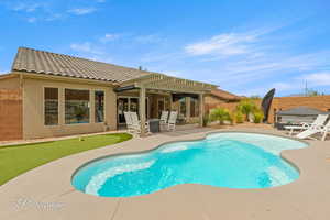 Rear view of property featuring a patio area, a fenced backyard, stucco siding, and a tiled roof