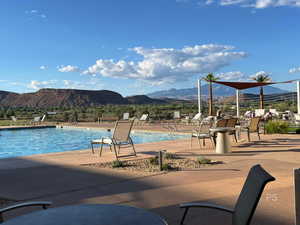 Community pool with a mountain view and a patio