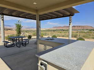 Fenced backyard with a pergola, a patio, and a mountain view