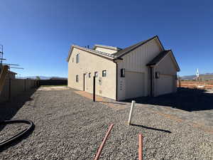 View of home's exterior featuring a mountain view, driveway, board and batten siding, and a garage
