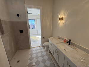 Bathroom with a tile shower and vanity