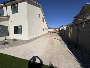 View of home's exterior featuring a fenced backyard and stucco siding