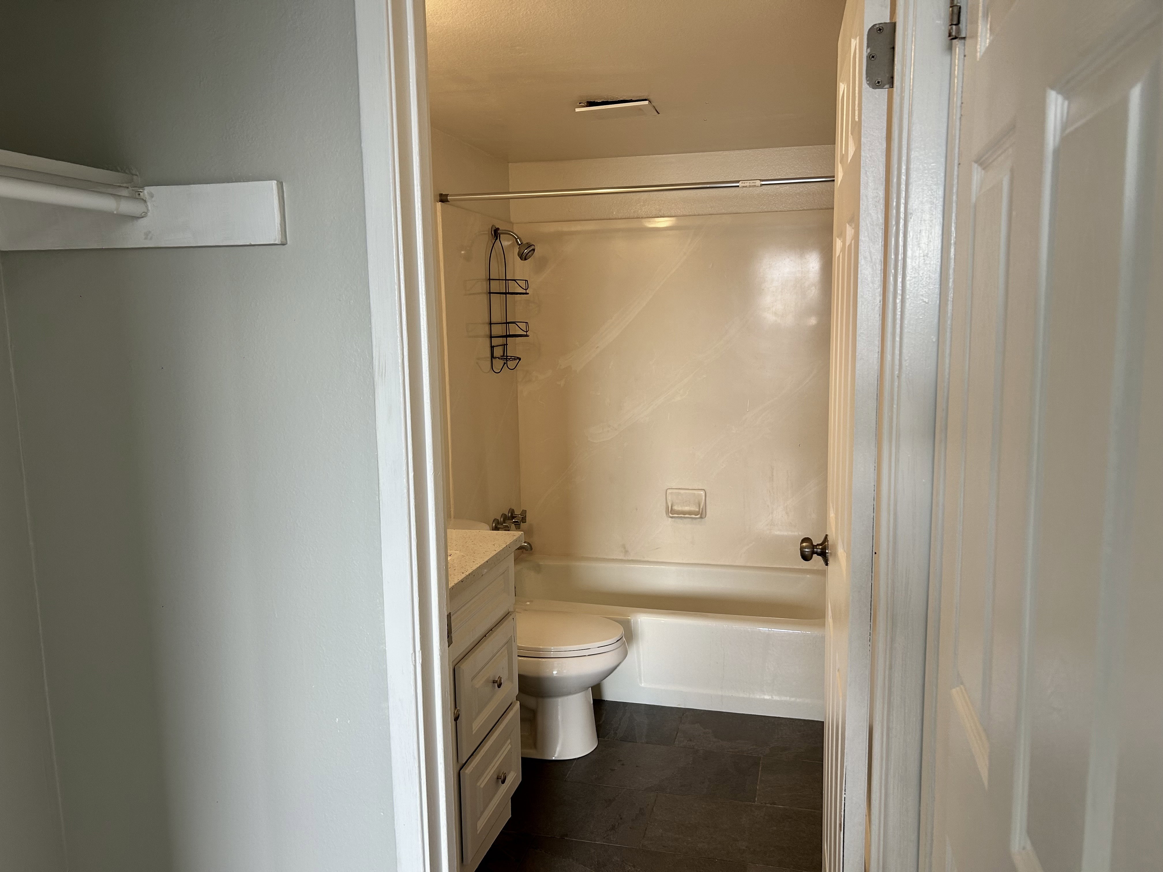 Bathroom featuring vanity and  shower combination