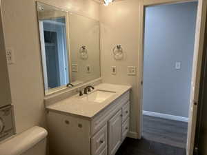Bathroom with a textured wall and vanity