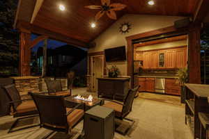 View of patio / terrace featuring a ceiling fan and an outdoor fire pit
