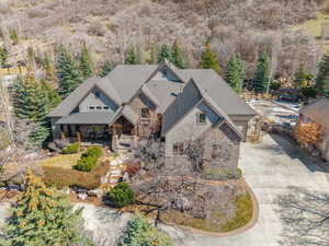 Aerial view of property and surrounding area featuring a heavily wooded area