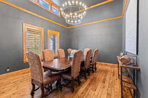 Dining room featuring light wood-type flooring and a chandelier