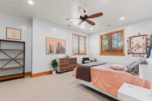 Bedroom featuring light carpet, ceiling fan, and recessed lighting