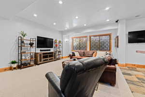 Living area featuring recessed lighting and light carpet