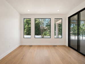 Dining nook with large windows, Interior space featuring light wood-finish flooring and recessed lighting