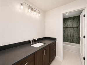 Bathroom vanity with a dark wood-finish cabinet and integrated sink.