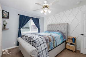Primary Bedroom with ceiling fan and carpet flooring