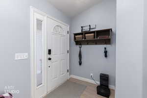 Mudroom featuring baseboards and light wood finished floors