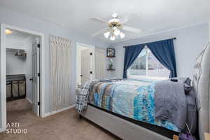 Primary Bedroom with carpet, ceiling fan, a textured ceiling, and a walk in closet