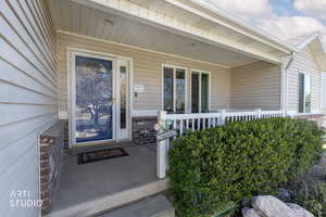 Doorway to property with covered porch
