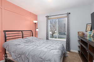 Bedroom 3 with light carpet and baseboards