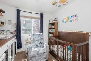 Bedroom 2 featuring light colored carpet and a crib