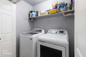 Laundry area featuring independent washer and dryer and a textured ceiling
