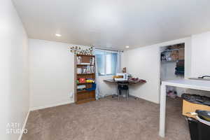 Office area with light carpet and recessed lighting