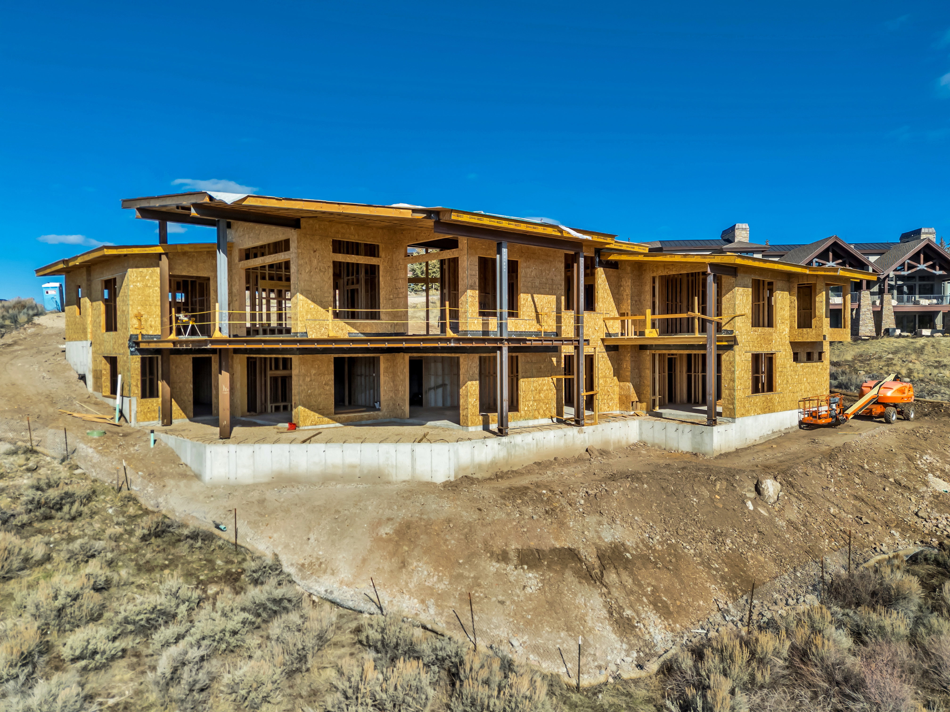 Rear view of house with a balcony, a patio area, and a metal roof