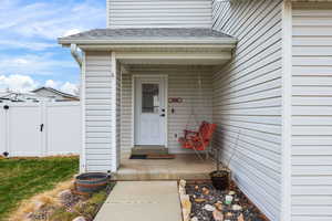 Entrance to property with roof with shingles and a gate