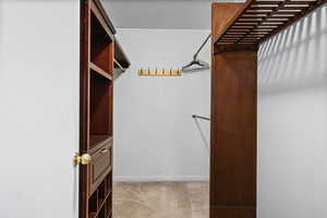 Walk in closet featuring light carpet