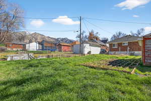 View of yard featuring a trampoline and a mountain view