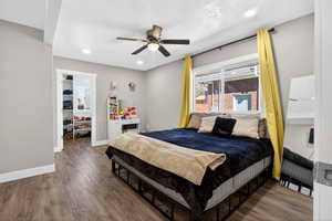 Bedroom with wood finished floors, ceiling fan, recessed lighting, and a textured ceiling