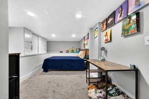 Carpeted bedroom with recessed lighting