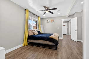 Bedroom featuring wood finished floors, a ceiling fan, and a textured ceiling