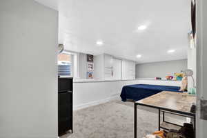Carpeted bedroom featuring recessed lighting and a textured ceiling