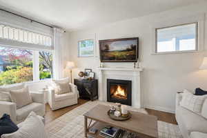 Living Room with original fireplace, red oak hardwood floors