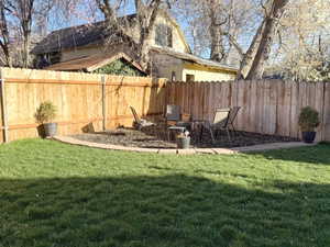 View of fenced backyard with firepit area
