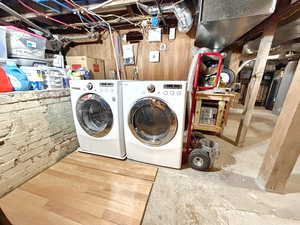 Unfinished walkout basement with laundry area, utility area and ample storage