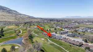 Aerial view of Eagle Crest featuring a golf club and pond and mountain view