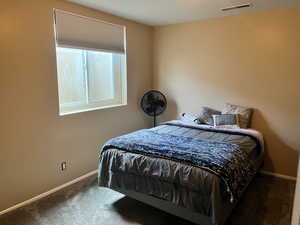 Bedroom featuring carpet flooring and baseboards