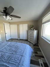 Bedroom 1 with two closets, and a ceiling fan