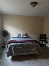 Bedroom featuring carpet flooring and baseboards