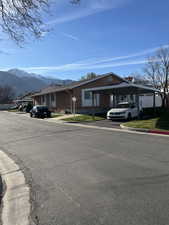 Ranch-style house featuring a mountain view and brick siding