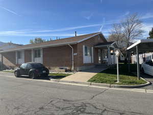 View of front of home with brick siding and a front yard