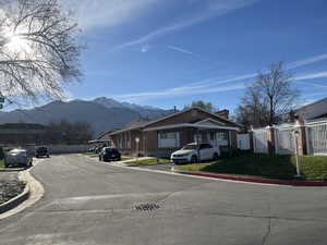 View of asphalt street featuring curbs and a mountain view
