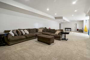 Carpeted living room with recessed lighting