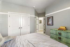 Bedroom featuring a closet and a textured ceiling