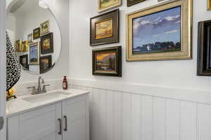 Bathroom with wainscoting and vanity